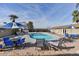 Community swimming pool with lounge chairs and umbrellas at 16210 N 32Nd Way, Phoenix, AZ 85032
