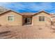 Backyard view showing home exterior and gravel landscaping at 1727 N 213Th Dr, Buckeye, AZ 85396