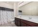 Clean bathroom with double vanity, shower, and tile flooring at 1727 N 213Th Dr, Buckeye, AZ 85396