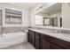 Elegant bathroom with double vanity and soaking tub at 1727 N 213Th Dr, Buckeye, AZ 85396