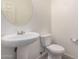 Clean bathroom with pedestal sink and toilet at 1727 N 213Th Dr, Buckeye, AZ 85396