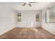 Bright bedroom with two windows and ceiling fan at 1727 N 213Th Dr, Buckeye, AZ 85396