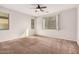 Well-lit bedroom with window and ceiling fan at 1727 N 213Th Dr, Buckeye, AZ 85396