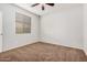 Bright bedroom featuring carpet flooring and a window with blinds at 1727 N 213Th Dr, Buckeye, AZ 85396