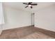 Spacious bedroom with ceiling fan and neutral carpeting at 1727 N 213Th Dr, Buckeye, AZ 85396