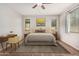Bright bedroom with a large bed, soft lighting, and a dedicated workspace, perfect for relaxation and productivity at 1727 N 213Th Dr, Buckeye, AZ 85396