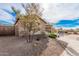 Tan house with a side view showcasing a wooden fence and driveway at 1727 N 213Th Dr, Buckeye, AZ 85396