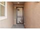 Front entry with iron security door featuring a coyote and cactus design at 1727 N 213Th Dr, Buckeye, AZ 85396