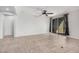 Bright living room with tile floors, sliding glass doors, and ceiling fan at 1727 N 213Th Dr, Buckeye, AZ 85396