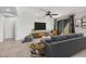 Cozy living room with comfortable seating, neutral color scheme, and entertainment center, creating a relaxing atmosphere at 1727 N 213Th Dr, Buckeye, AZ 85396