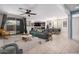 Open-concept living room with large windows, neutral tones, contemporary decor, and seamless flow to the dining area at 1727 N 213Th Dr, Buckeye, AZ 85396