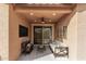 Cozy outdoor patio with comfortable seating, stylish decor, and a relaxing ambiance, ideal for leisure and entertainment at 1727 N 213Th Dr, Buckeye, AZ 85396
