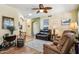 Living room with leather furniture, wood floors, and a ceiling fan at 17937 W Udall Dr, Surprise, AZ 85374