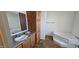 Bathroom features a vanity, tub, and wood flooring at 18002 N 20Th N Pl, Phoenix, AZ 85022