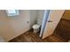 Clean bathroom with toilet and wood-look flooring at 18002 N 20Th N Pl, Phoenix, AZ 85022