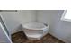 Corner bathtub with built-in step in a bright bathroom at 18002 N 20Th N Pl, Phoenix, AZ 85022