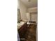 Bathroom with wood vanity, tub shower combo, and vinyl flooring at 18002 N 20Th N Pl, Phoenix, AZ 85022