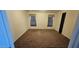 Simple bedroom with carpet flooring and two windows at 18002 N 20Th N Pl, Phoenix, AZ 85022