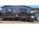 Single-wide manufactured home with wooden deck and fenced yard at 18002 N 20Th N Pl, Phoenix, AZ 85022