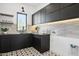 Stylish laundry room with dark cabinetry, patterned flooring and window at 1819 E Myrtle Ave, Phoenix, AZ 85020