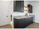 Modern wet bar with dark cabinets and a built-in wine cooler at 1819 E Myrtle Ave, Phoenix, AZ 85020