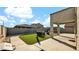 Artificial turf backyard with patio furniture, covered patio, and built-in grill at 18225 W Foothill Dr, Surprise, AZ 85387