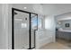 Bathroom with shower and tub, and view into bedroom at 18225 W Foothill Dr, Surprise, AZ 85387
