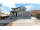 Two-story house with gray siding, a three-car garage, and a landscaped front yard at 18225 W Foothill Dr, Surprise, AZ 85387