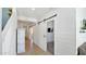 Hallway with barn doors and white shiplap walls at 18225 W Foothill Dr, Surprise, AZ 85387