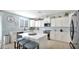 Spacious kitchen with white cabinets, quartz countertops, and an island at 18225 W Foothill Dr, Surprise, AZ 85387