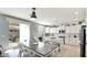 Kitchen with white cabinets, center island, and view to backyard at 18225 W Foothill Dr, Surprise, AZ 85387