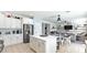 Open kitchen features white cabinets, island, and adjacent living room at 18225 W Foothill Dr, Surprise, AZ 85387