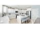 Bright kitchen boasts white cabinets, an island, and subway tile backsplash at 18225 W Foothill Dr, Surprise, AZ 85387