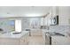 Modern kitchen with white cabinets, quartz countertops, and farmhouse sink at 18225 W Foothill Dr, Surprise, AZ 85387