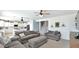 Open living room featuring a kitchen, and two gray couches with an ottoman at 18225 W Foothill Dr, Surprise, AZ 85387
