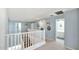 Upstairs hall with bathroom access and white railings at 18225 W Foothill Dr, Surprise, AZ 85387