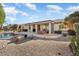 Home exterior with covered patio and pool area at 18752 N Cactus Flower Way, Surprise, AZ 85387