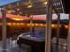 Relaxing backyard with hot tub, pergola, and string lights at sunset at 19217 N 262Nd Dr, Buckeye, AZ 85396