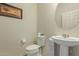 Clean and updated bathroom with pedestal sink and toilet at 19217 N 262Nd Dr, Buckeye, AZ 85396