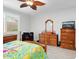 Spacious bedroom with wood furniture, ceiling fan, and tiled floor at 20416 W Calle Encorvada Ln, Buckeye, AZ 85396