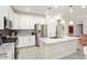 Bright kitchen with white cabinets, granite countertops, and stainless steel appliances at 20416 W Calle Encorvada Ln, Buckeye, AZ 85396