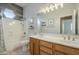 Bathroom boasts double sinks, wood cabinets, and shower/tub combo at 20897 S Tiberius Dr, Queen Creek, AZ 85142