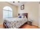 Bedroom with a queen-size bed and an arched window at 23918 N 163Rd Dr, Surprise, AZ 85387