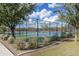 Well-lit tennis courts surrounded by trees and landscaping at 2528 N Petersburg Dr, Florence, AZ 85132