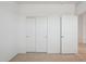 Neat bedroom with bi-fold closet doors, carpet, and fresh white walls at 25425 W Graham Trl, Buckeye, AZ 85326
