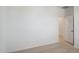 Bright bedroom with neutral carpet and white walls, next to a door at 25425 W Graham Trl, Buckeye, AZ 85326