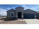 Charming single-story home boasts a well-maintained xeriscaped front yard and neutral colored stucco at 25425 W Graham Trl, Buckeye, AZ 85326