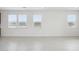 Bright living room features tile flooring, neutral paint and ample windows at 25425 W Graham Trl, Buckeye, AZ 85326