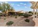 Landscaped backyard with a fence and mature plants at 26180 W Firehawk Dr, Buckeye, AZ 85396