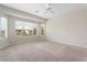 Spacious bedroom with carpeted floors and large window at 26180 W Firehawk Dr, Buckeye, AZ 85396